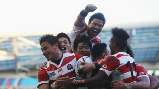 History: Japan celebrate their upset win over two-time champions South Africa.