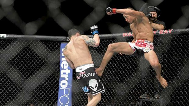 Jose Aldo kicks Frankie Edgar during their UFC 156 featherweight title bout.