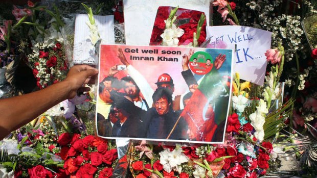 Flower and get-well messages for Imran Khan are placed outside the hospital in Lahore.