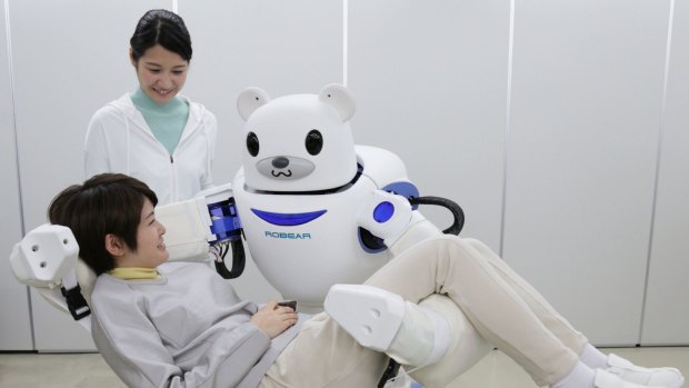 Future caregiver ... Robear lifts a woman during a showcase in Nagoya, central Japan. 