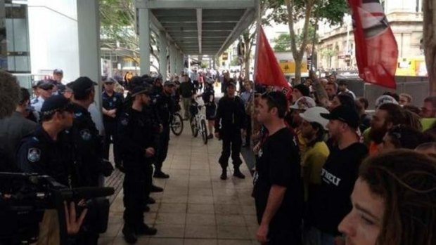 Police watch closely as anti-fascist protesters and Australia First Party members collide in Brisbane.