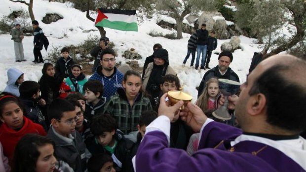 Father Ibrahim Shomali (right), Beit Jala's Roman Catholic parish priest, leads a pre-Christmas celebration in the Cremisan Valley near the West Bank city of Bethlehem.