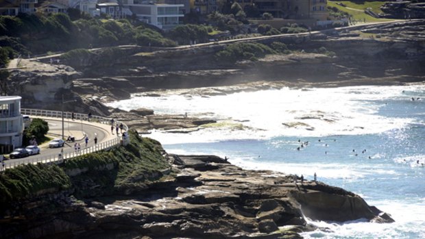 Top of 28 degrees predicted ... surfers take to the water between Bronte and Bondi beaches.