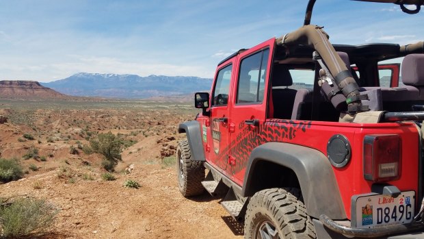 Enjoy the wind in your hair aboard a Zion Jeep Tours' open-top red jeep.