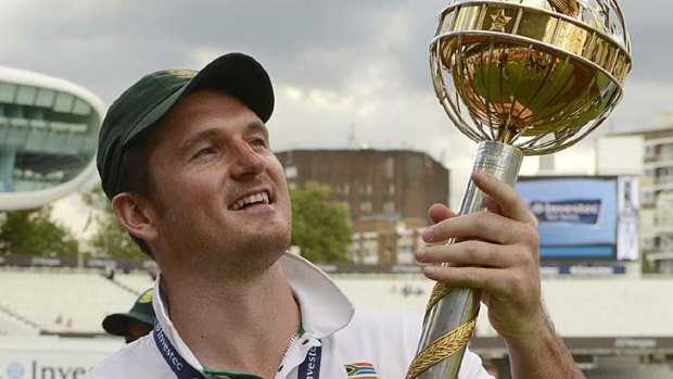 On top ... South African captain Graeme Smith holds the ICC World Test  trophy.
