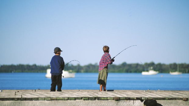 Wild times ... boys fishing off a Caloundra wharf.