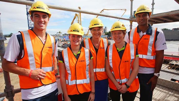 Federal Sports Minister Kate Lundy (centre) with Australian cricketers (left to right) Pat Cummins, Jess Jonassen, Alex Blackwell and Gurinder Sandhu tour the Cricket Centre of Excellence construction site in Brisbane on Friday.