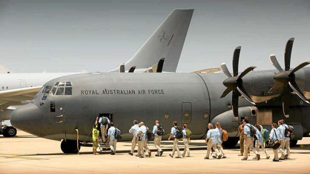 A civilian Australian Medical Assistance Team boards a C-130 Hercules at RAAF Base Darwin enroute to  to the Philippines to conduct emergency relief operations following Typhoon Haiyan.