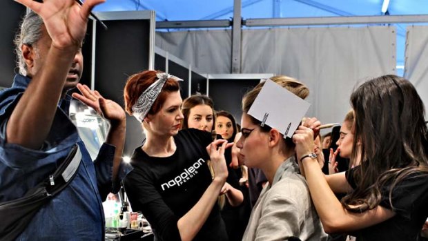 Getting a stitch ... after lengthy preparations, the final minutes are frenetic backstage for the team putting on Toni Maticevski's show in Rosebery yesterday.