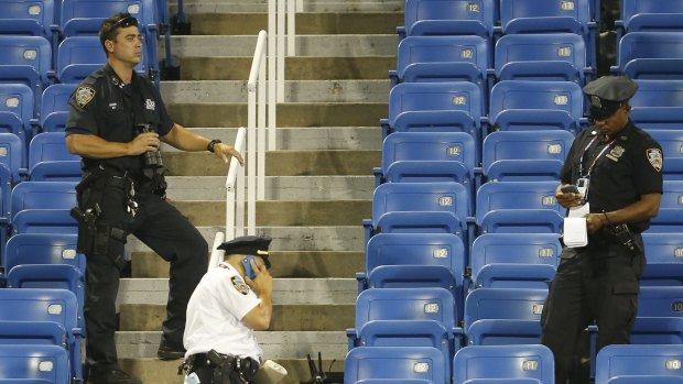 Police officers stand beside a drone that crashed into an empty section of seats at the US Open tennis tournament at Flushing Meadows, New York. 