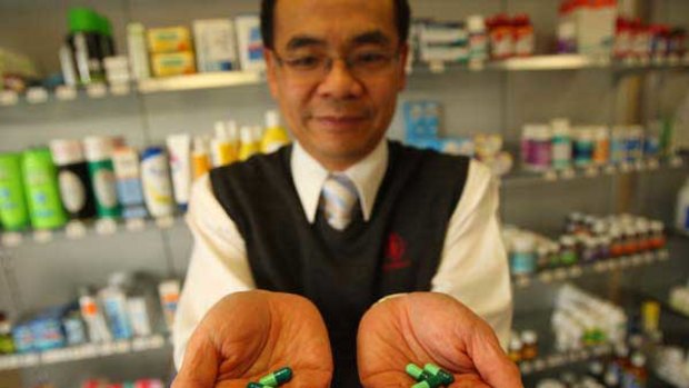 Alphington pharmacist Sam Chanholds Keflex brand antibiotic in his right hand and a generic version, Cilex. <i>Picture: Ken Irwin</i>