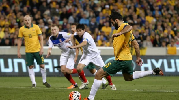 Back of the net: Mile Jedinak scores from a penalty kick against Kyrgyzstan in the World Cup qualifier at Canberra last Thursday.