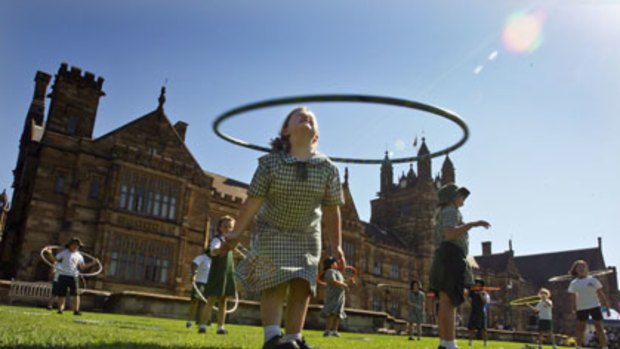 Making education fun ... eight-year-old Katherine Willows enjoys a hula hoop session on the grounds of the University of Sydney.