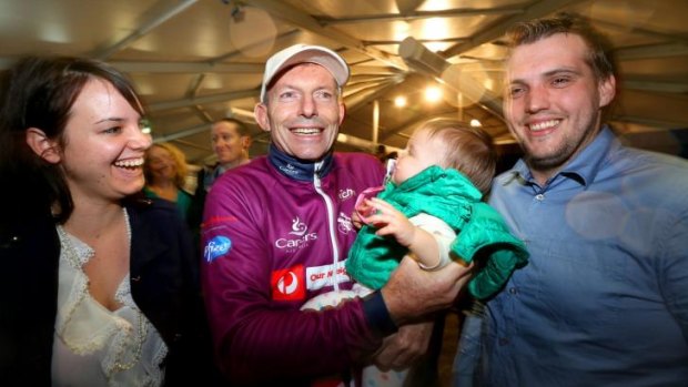 Tony Abbott greets local Councillor Ben Goldfinch and his wife Rebecca and baby Dakota.