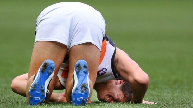 Jonathon Patton grimaces in pain as he suffers a knee injury against Melbourne on Sunday.