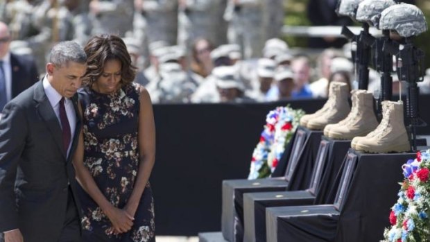 President Barack Obama and first lady Michelle Obama turn to leave after paying their respects during a memorial ceremony at Fort Hood Texas.