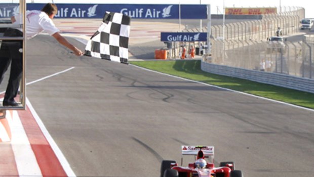 Spaniard Fernando Alonso crosses the finish line to win last year's Bahrain Grand Prix.