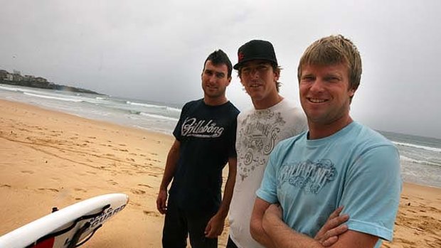 Surfing community in shock ... Andy Irons, centre, who was found dead in a Dallas hotel room yesterday, with fellow surfers Joel Parkinson and Taj Burrow on Manly Beach.