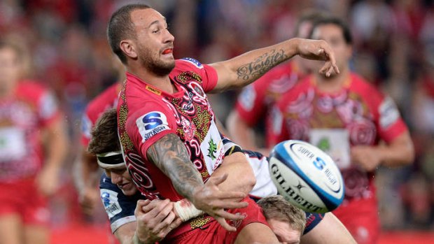 Quade Cooper gets the ball away in close contact against the Rebels at Suncorp Stadium on Saturday night.
