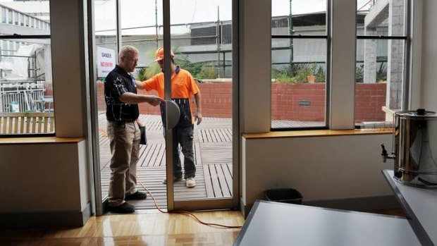 CFMEU secretary Dean Hall talks to a worker about unsafe building practices at the ACT Legislative Assembly on Monday.