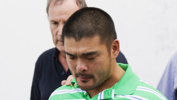 Andrew Chan's brother, Michael, holds back tears.