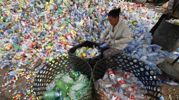 A worker separates plastic bottles at a recycling depot in Beijing.