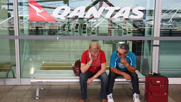 Grounded ... a Qantas captain suspected of drinking before her shift last Monday. Above, delayed passengers.