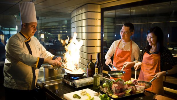 Social sizzle ... the Regent hotel in Singapore offers cooking classes for guests.