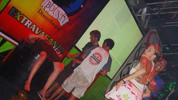 Tourists dance at Bounty Discotheque in Legian, scene of the stabbing of two Australians during a bar brawl.