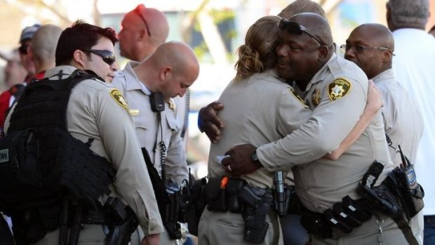 Las Vegas police officers hug near a Wal-Mart in the aftermath of the killings.