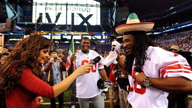 Televisa reporter Marisol Gonzalez interviews players from the New York Giants.