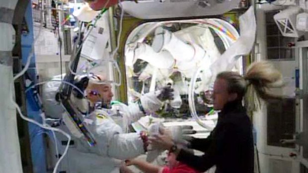 Walk abandoned: US astronaut Karen Nyberg assists Italian astronaut Luca Parmitano after water began building up inside his helmet.