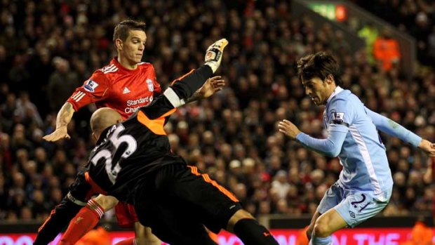 Spanish armada ... David Silva tries to shoot past Liverpool goalkeeper Pepe Reina.