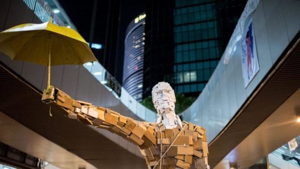 The statue "Umbrella Man" by the Hong Kong artist known as Milk, is set up at a pro-democracy protest site next to the central government offices in Hong Kong.