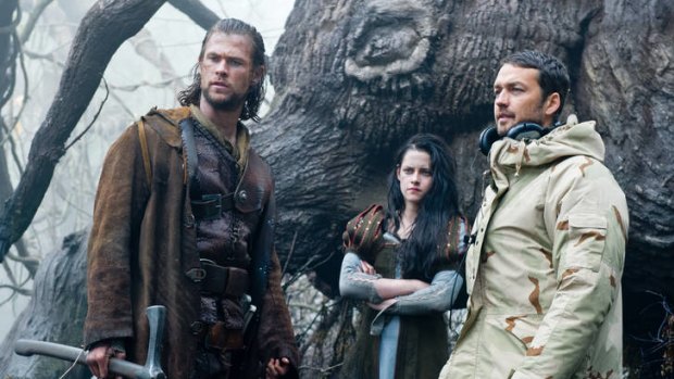 Kristen Stewart on the set of <i>Snow White and the Huntsman</i> with Chris Hemsworth and director Rupert Sanders.