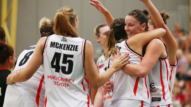 The Townsville Fire celebrate their win against the Dandenong Rangers.