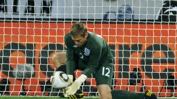 Robert Green of England misjudges the Jabulani ball and lets in a goal during the Group C game against the USA.