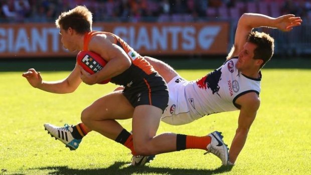 Toby Greene of the Giants and Matthew Wright of the Crows clash during the match between Greater Western Sydney and Adelaide.