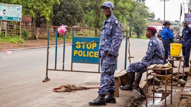 Police guard a roadblock as the government enforces a three-day lockdown on the movement of all people in Sierra Leone.