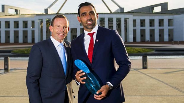 Adam Goodes is congratulated by Tony Abbott.