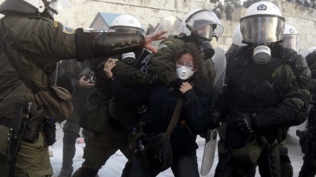 A woman is arrested by riot police during a huge anti-austerity demonstration in Athens' Syntagma (Constitution) square.