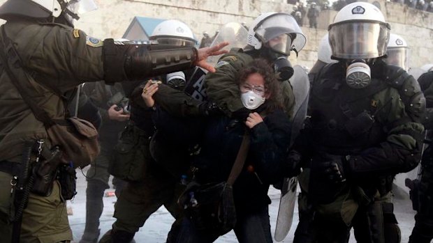 A woman is arrested by riot police during a huge anti-austerity demonstration in Athens' Syntagma (Constitution) square.