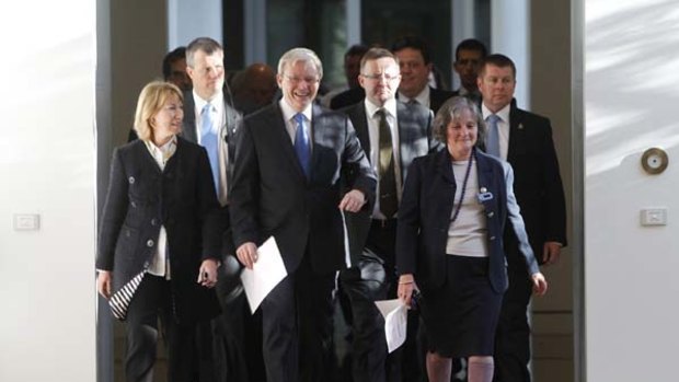 Prime Minister Kevin Rudd smiles bravely as he heads off to a leadership ballot against his deputy Julia Gillard.
