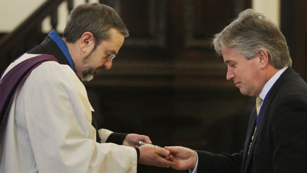 Unusual ceremony ... The Lord Mayor of London Nick Anstee, right, has his mobile phone blessed.