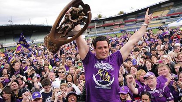 Brett White laps up the adoration as he shows off the Storm's 2009 NRL premiership trophy.