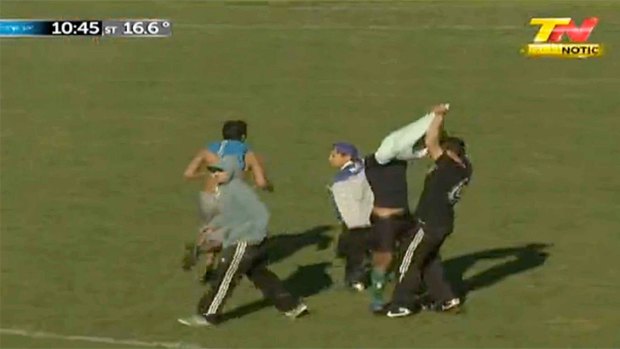 Hooligans remove the shirt of Deportivo Italiano midfielder Elias Di Biasi.