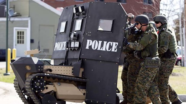 SWAT: The remote-controlled tank-like vehicle with a shield for officers.