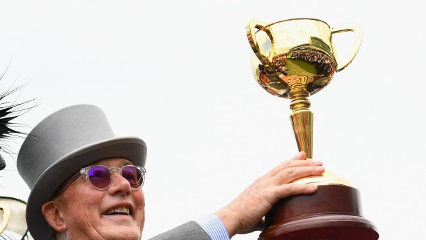 Number five: Lloyd Williams holds up the Melbourne Cup.