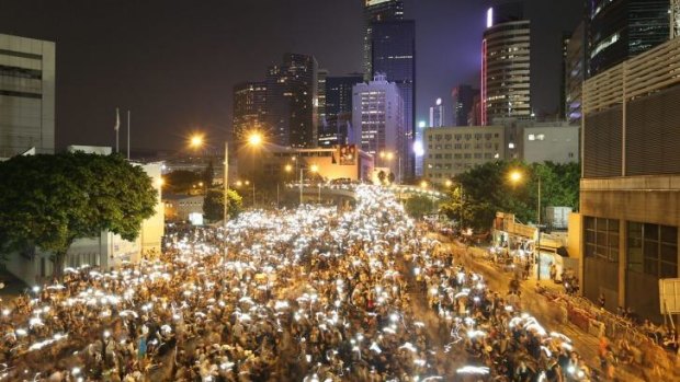 In this long exposure photo, pro-democracy protesters rally in the Admiralty region of Hong Kong.