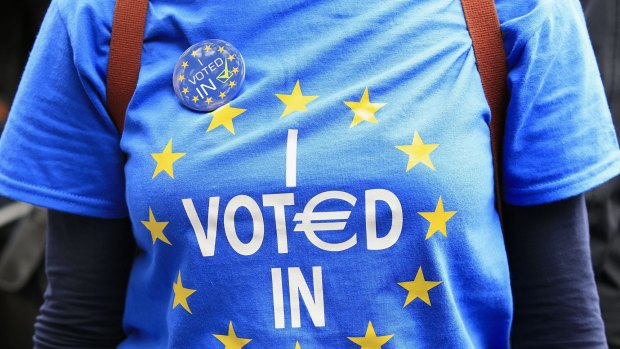 A Remain supporter walks near Park Lane in London, as protesters marched to Parliament Square to show their support for the European Union after Britain voted to EU.